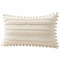 Cojín rectangular 50 x 30 cm de tejido beige con pompones estilo bohemio